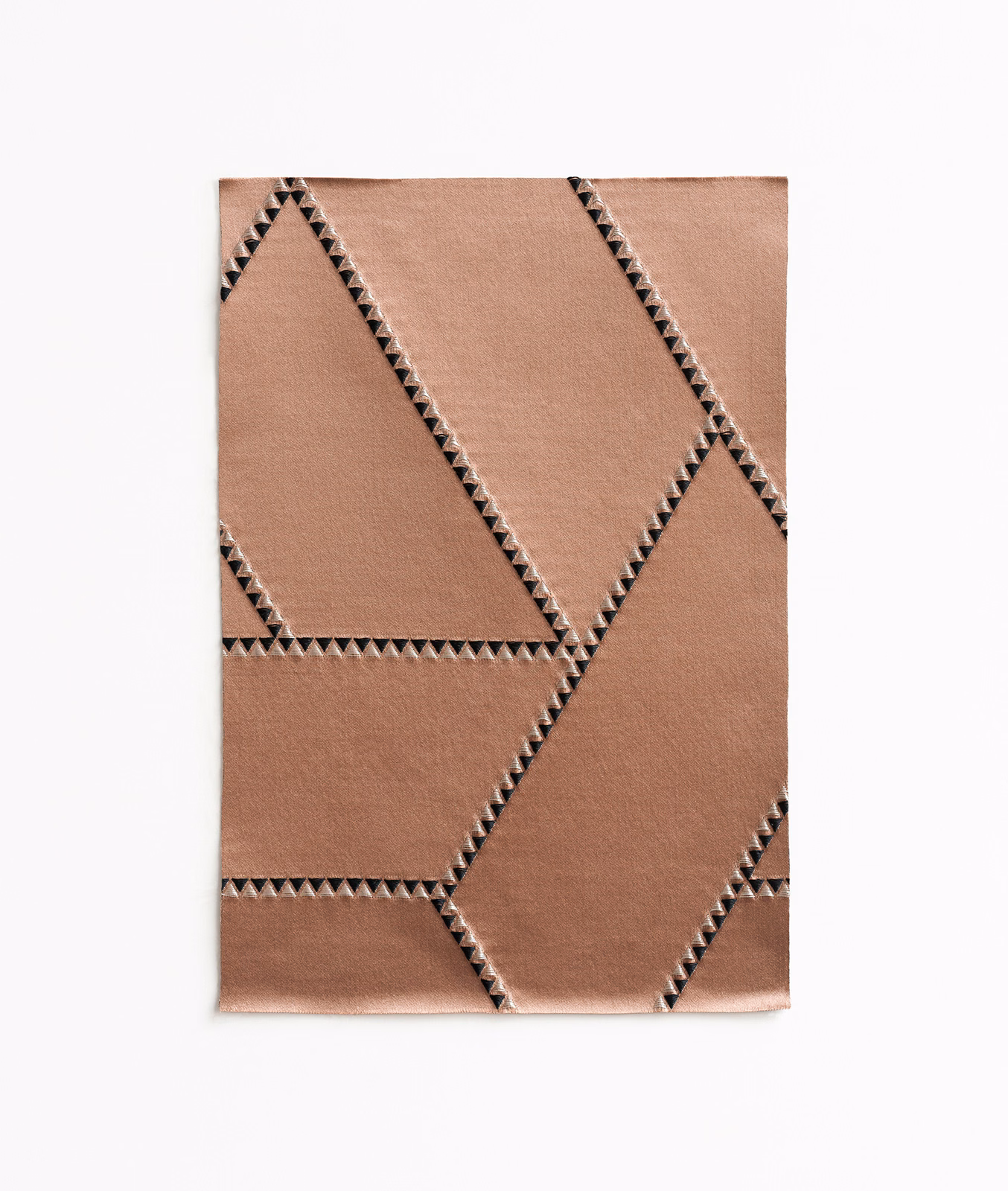 Warm cameo-taupe jacquard with large angular panels and dark zigzag edging
