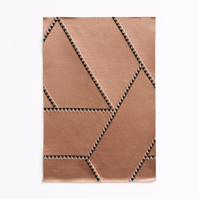 Warm cameo-taupe jacquard with large angular panels and dark zigzag edging