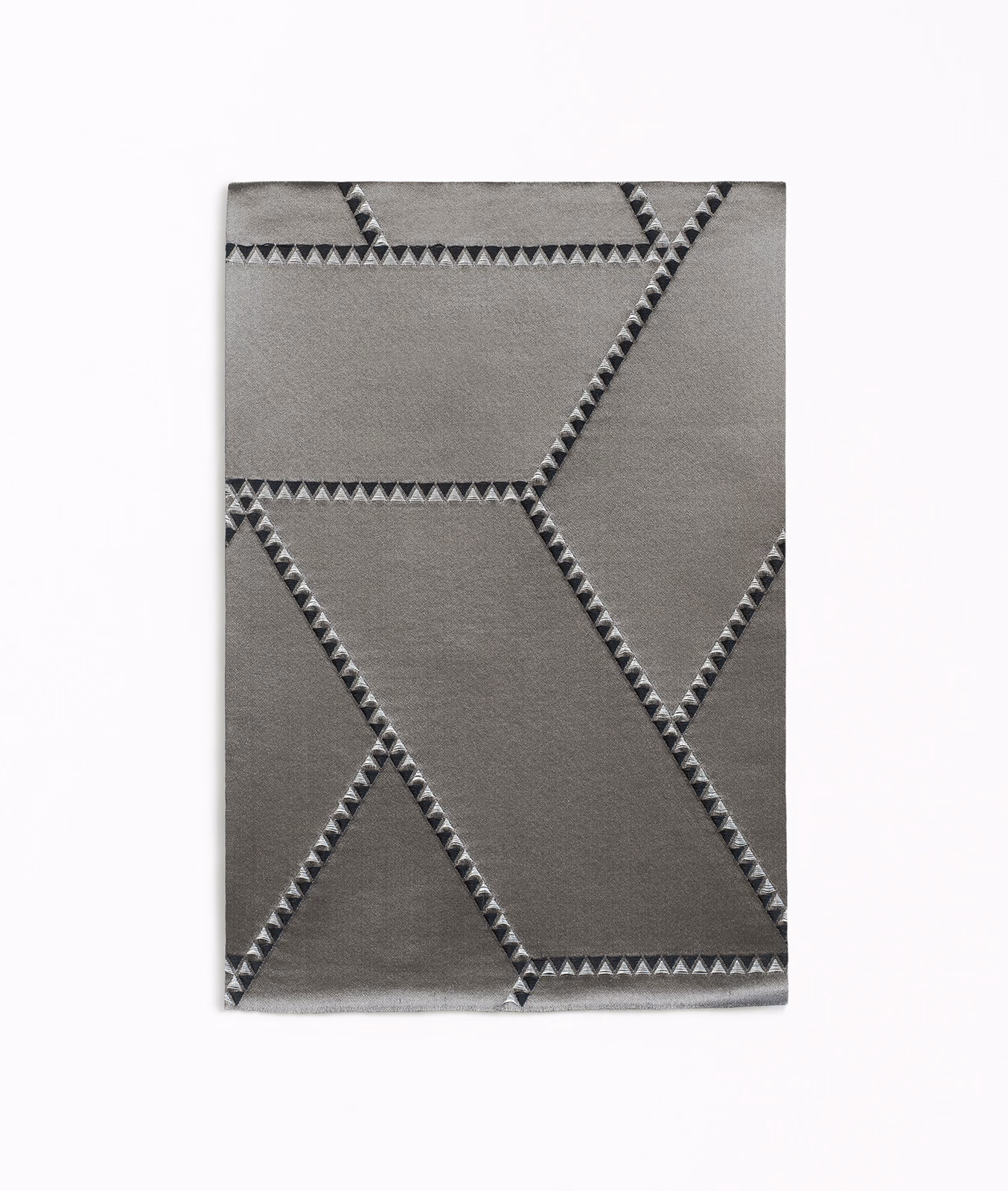 Graphite-grey jacquard with angular charcoal lines and triangular woven edging
