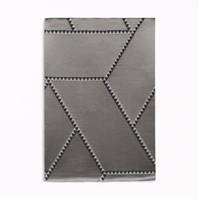 Graphite-grey jacquard with angular charcoal lines and triangular woven edging
