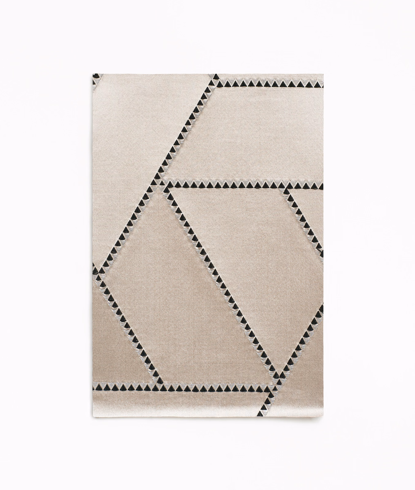 Ivory jacquard swatch with charcoal triangular borders forming oversized angular panels