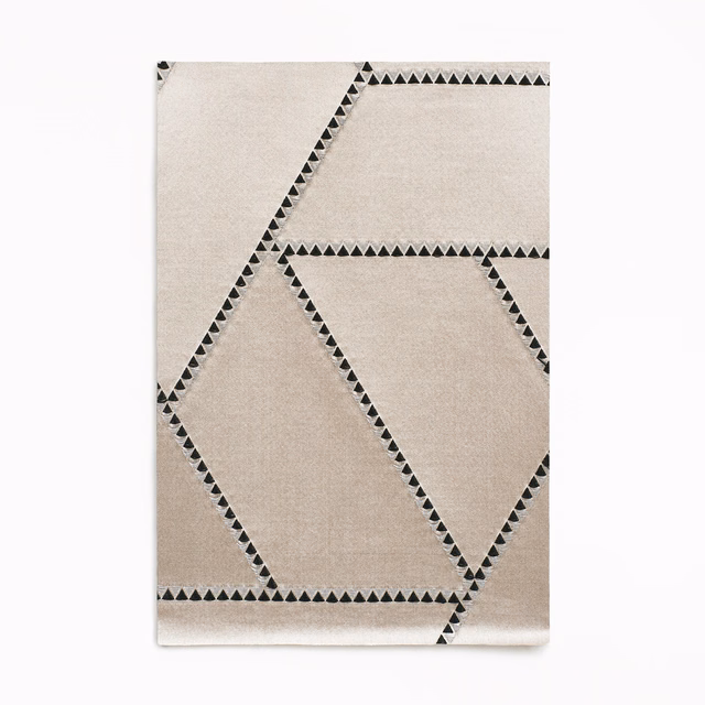 Ivory jacquard swatch with charcoal triangular borders forming oversized angular panels