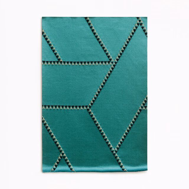 Deep malachite-teal jacquard with angular dark triangular lines and subtle sheen