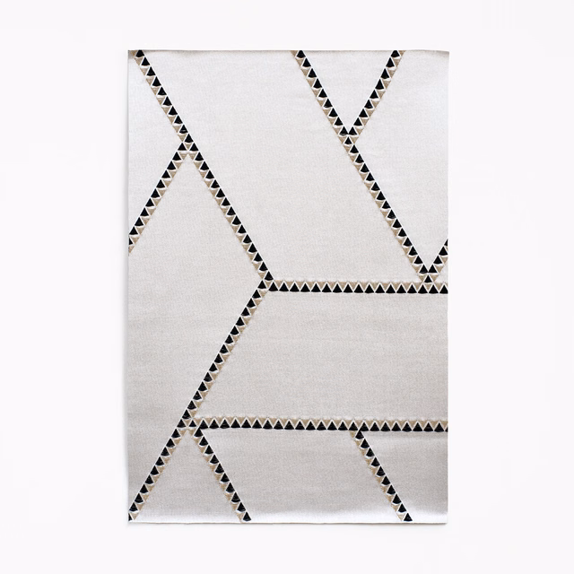 Soft white Jacquard with black triangular lines forming large angular geometric shapes