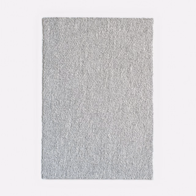 Pale cool-grey jacquard swatch with a dense, subtly vertical tactile weave
