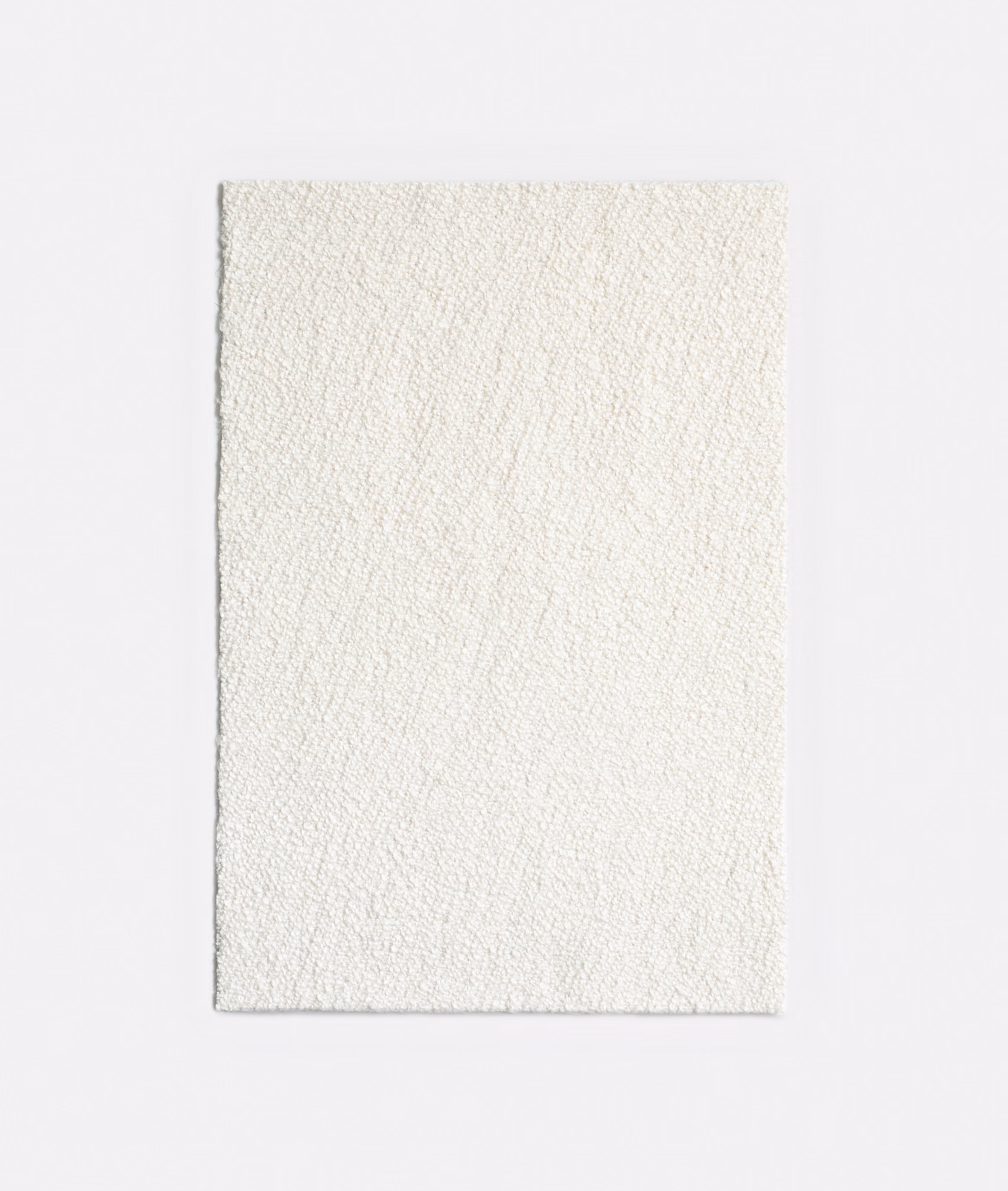 Ivory jacquard swatch with fine raised lines and softly textured near-white surface