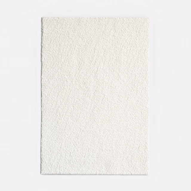 Ivory jacquard swatch with fine raised lines and softly textured near-white surface