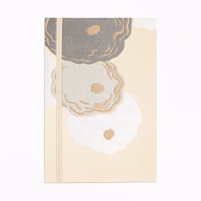 Warm ivory jacquard with charcoal, taupe and white scalloped floral motifs