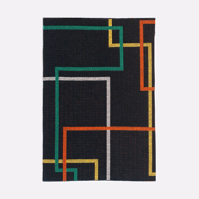 Black woven swatch with vivid green, orange, yellow and white geometric lines