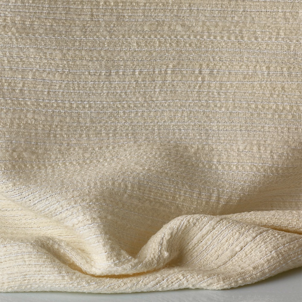 Warm ivory jacquard with irregular horizontal slubs and softly folded tactile surface