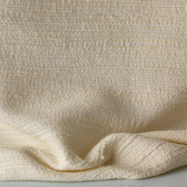 Warm ivory jacquard with irregular horizontal slubs and softly folded tactile surface