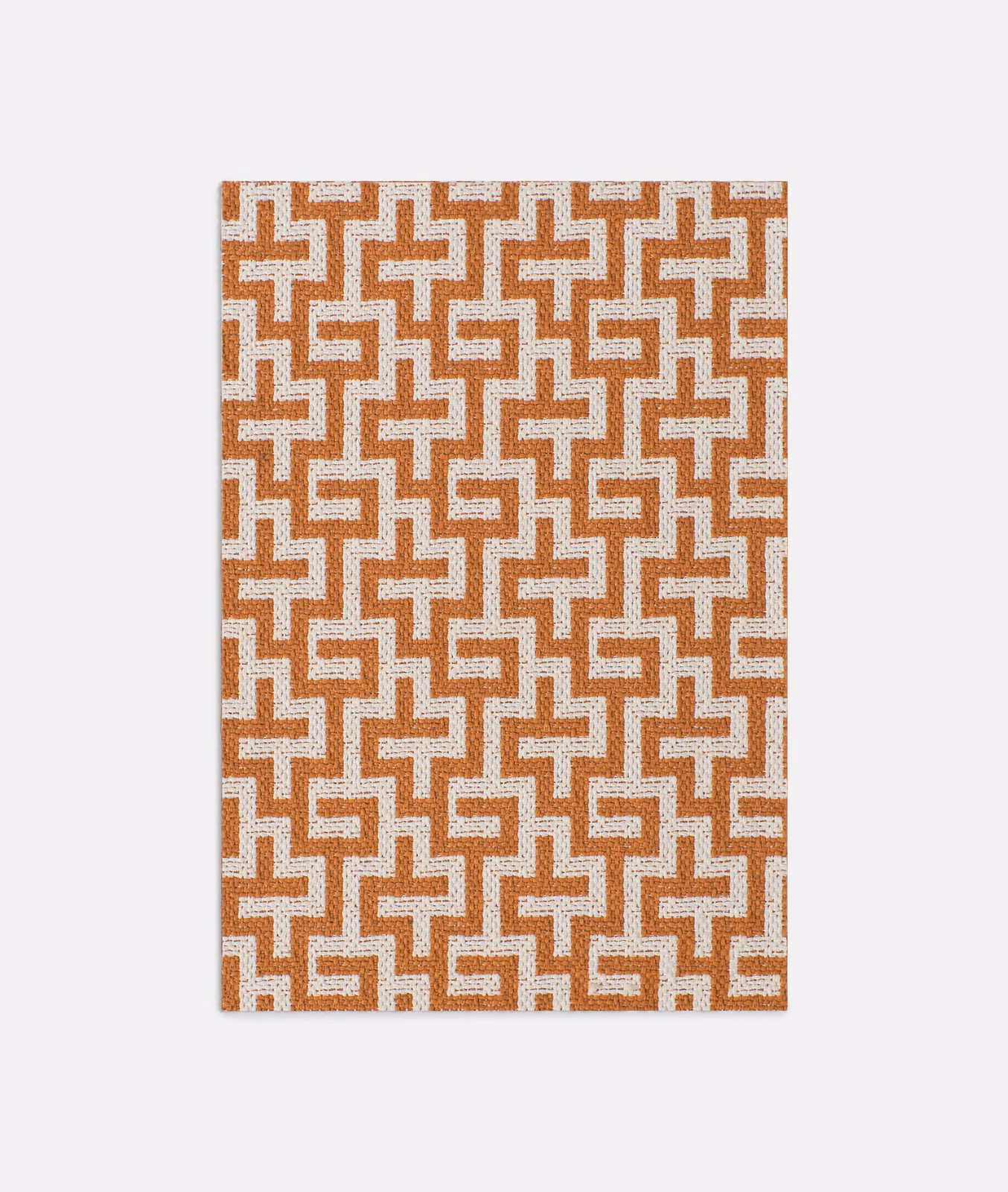 Papaya and ivory interlocking geometric jacquard with a lightly textured woven surface