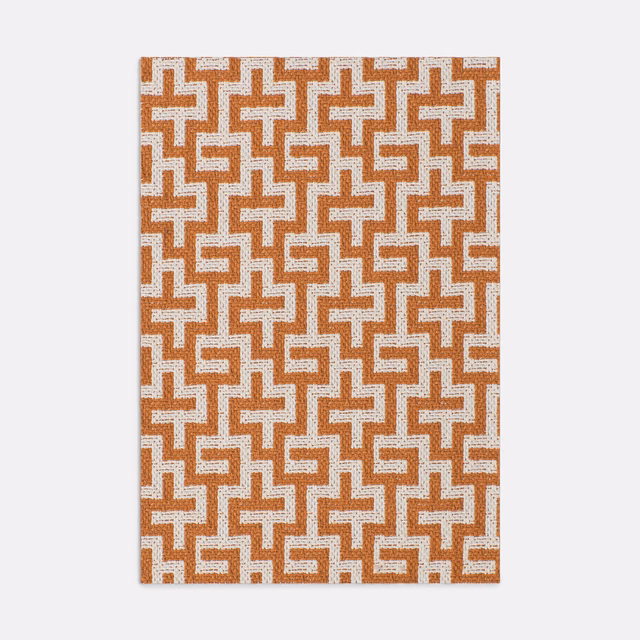 Papaya and ivory interlocking geometric jacquard with a lightly textured woven surface