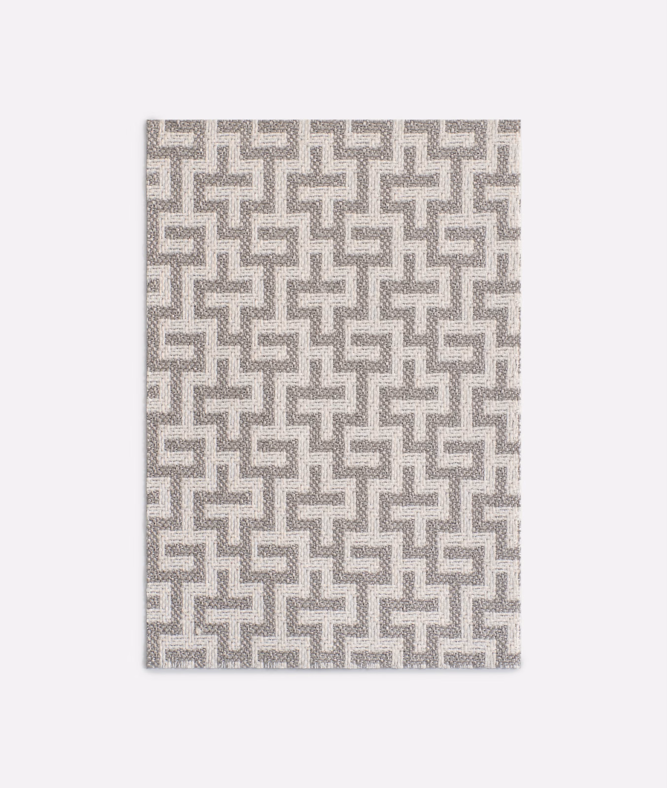 Pale pearl-grey jacquard with a repeating interlocking maze motif and softly mottled weave