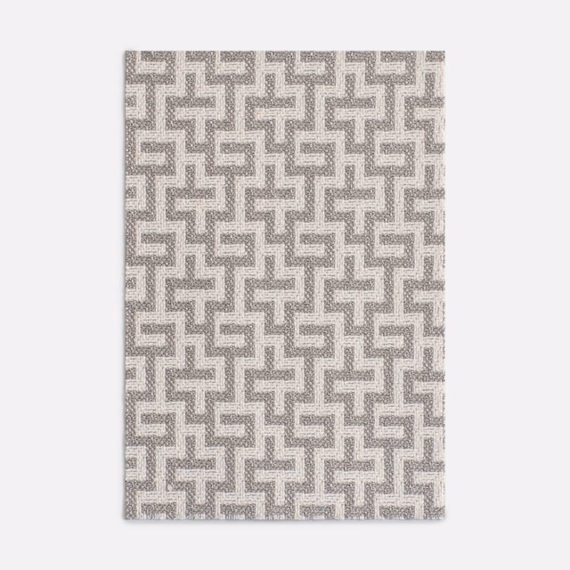 Pale pearl-grey jacquard with a repeating interlocking maze motif and softly mottled weave