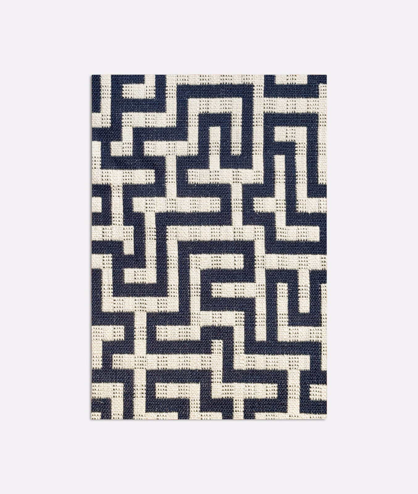 Deep navy and ivory jacquard showing an interlocking geometric maze pattern with textured weave