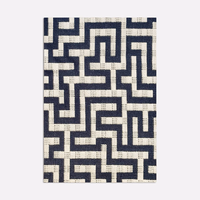 Deep navy and ivory jacquard showing an interlocking geometric maze pattern with textured weave