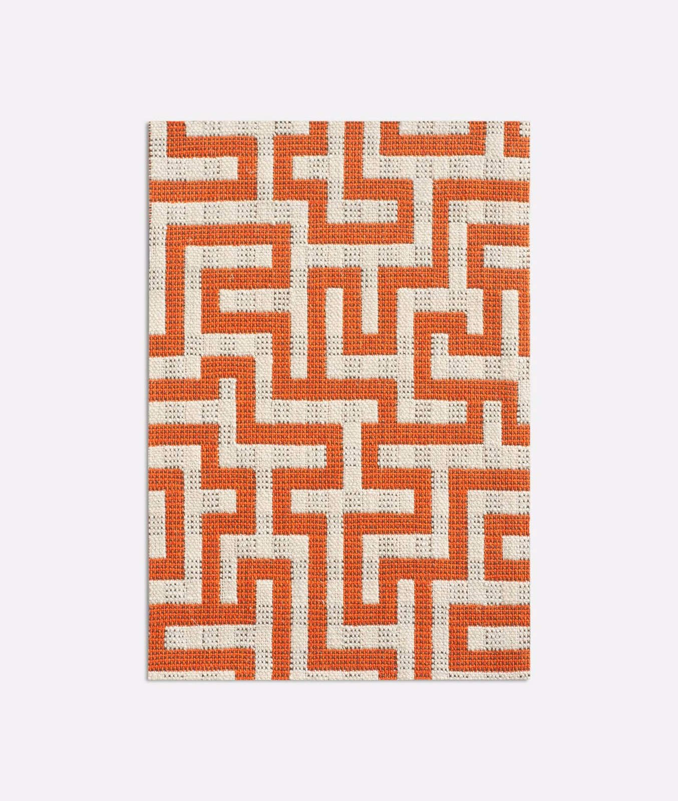 Warm brick-red angular maze pattern woven across a cream jacquard ground