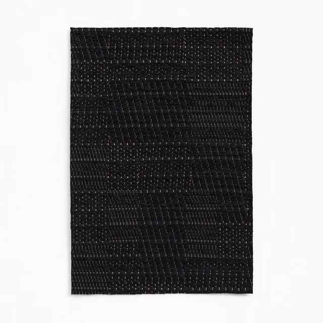 Deep black jacquard swatch with irregular horizontal texture and subtle woven highlights