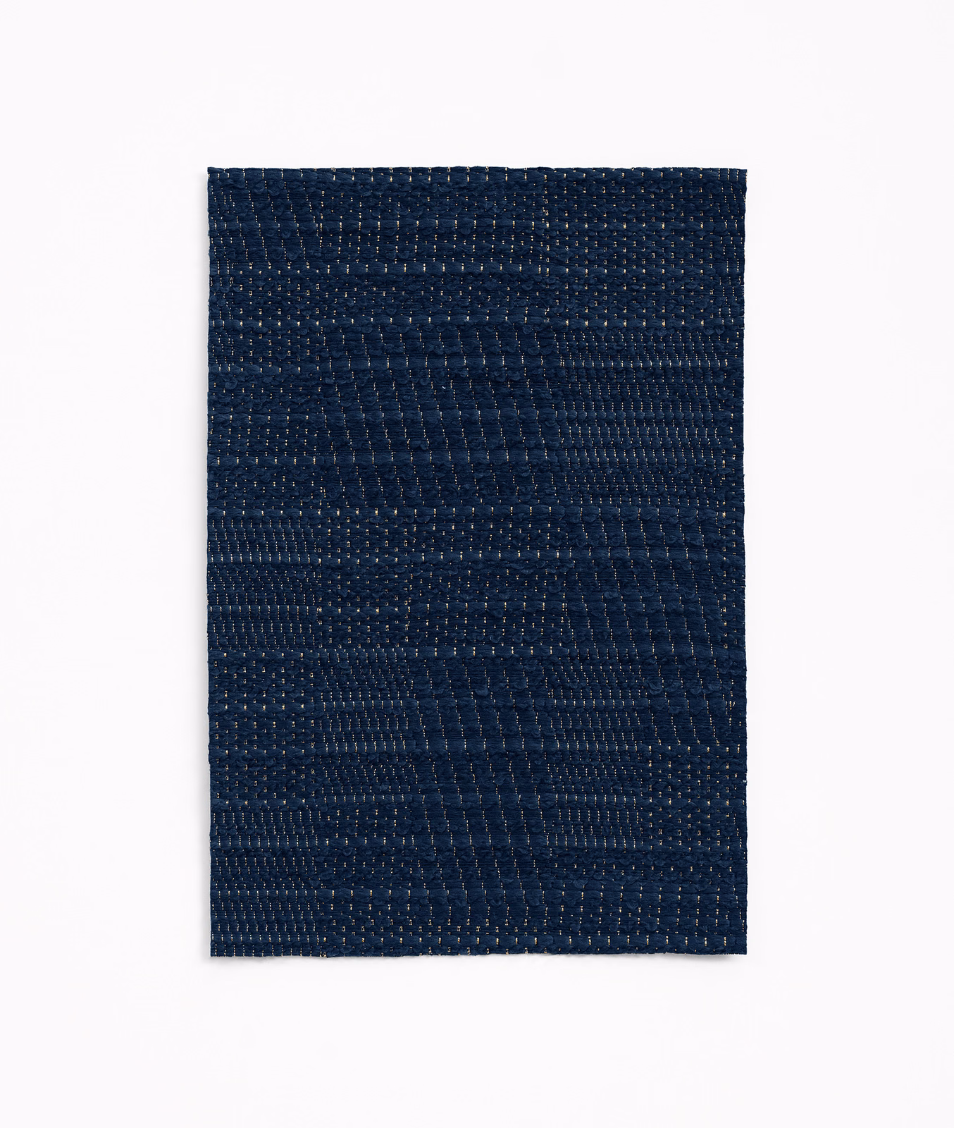 Deep marine-blue jacquard swatch with subtle patchwork bands and tactile woven texture