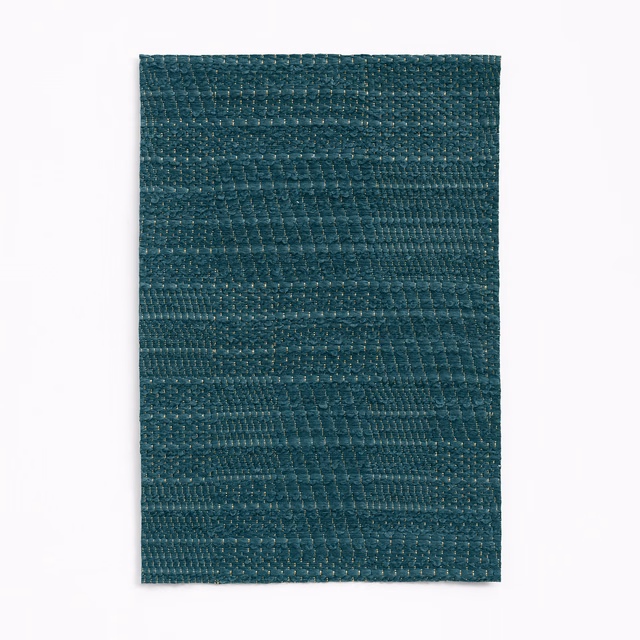 Deep blue teal jacquard swatch with irregular horizontal bands and pebbled woven texture