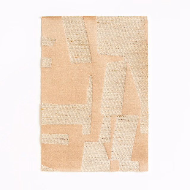 Peach-pink jacquard with raised cream geometric woven panels and tactile texture