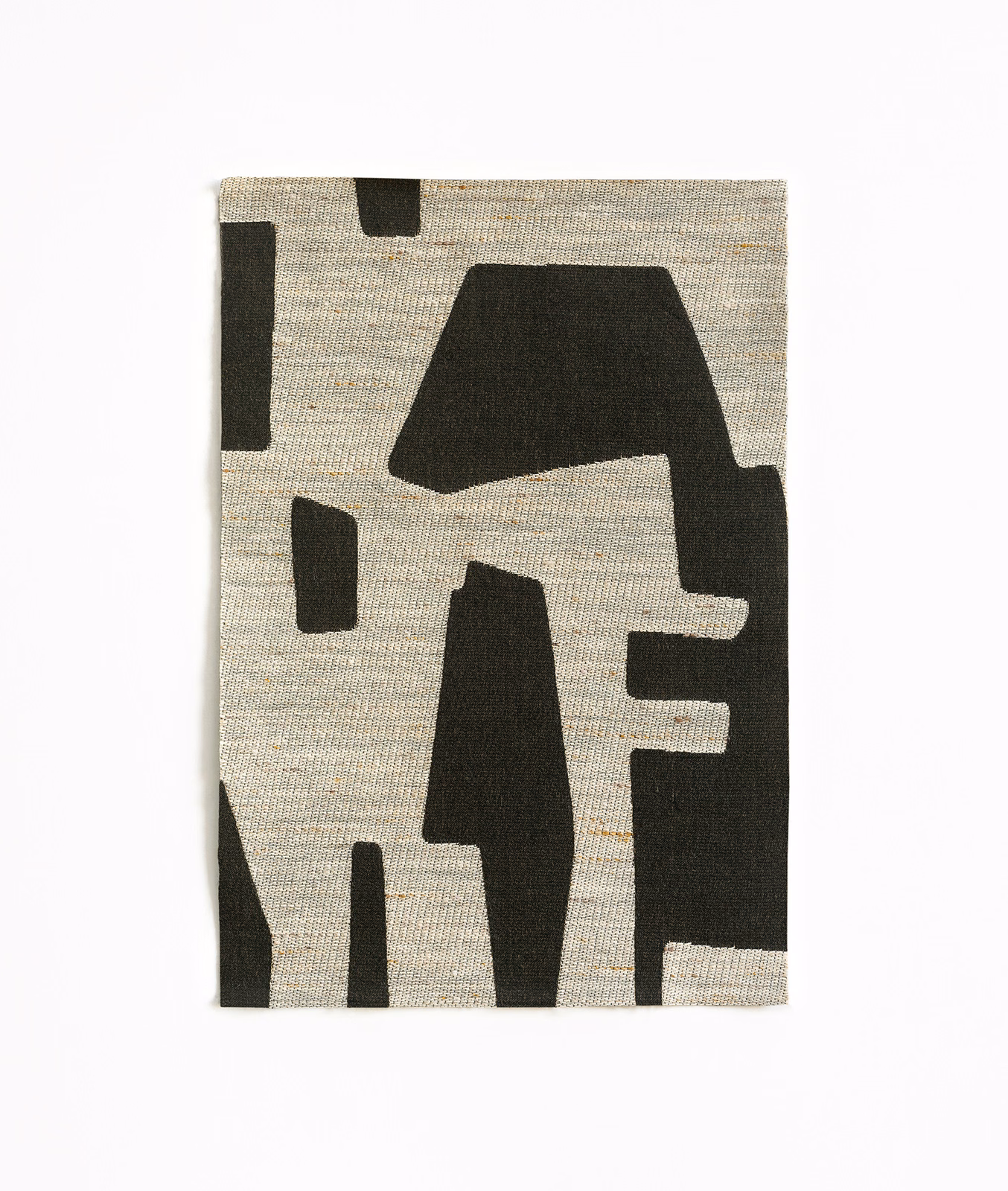 Charcoal geometric jacquard on an oatmeal-grey, horizontally textured woven ground