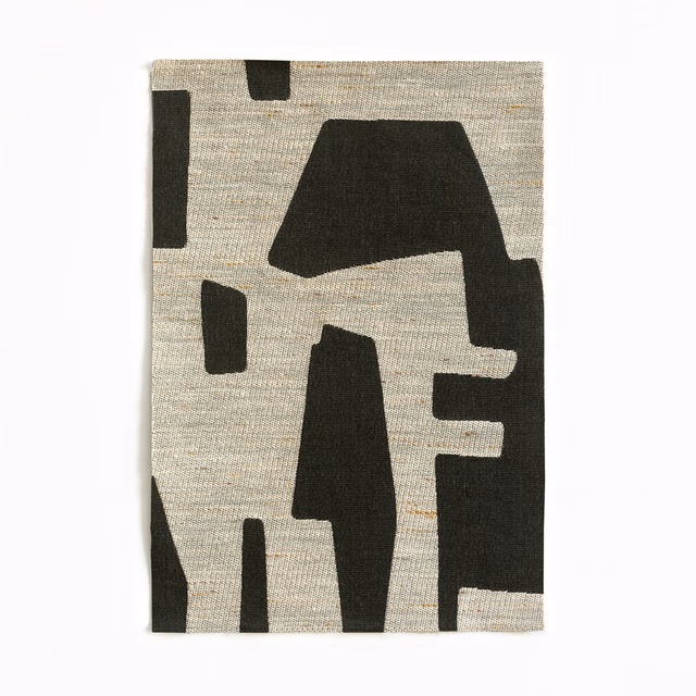 Charcoal geometric jacquard on an oatmeal-grey, horizontally textured woven ground