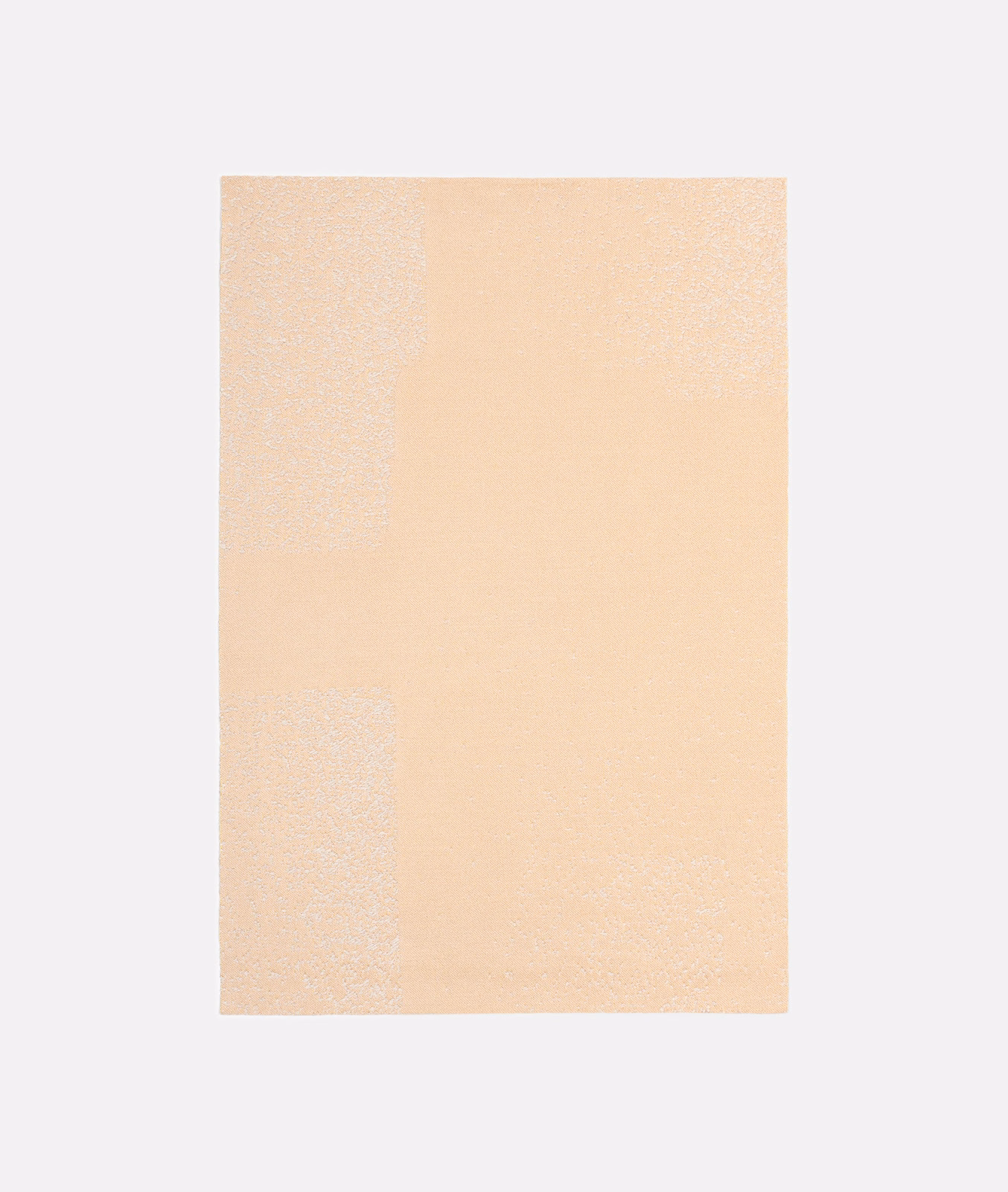 Pale peach jacquard with subtle tonal blocks and a softly granular woven texture