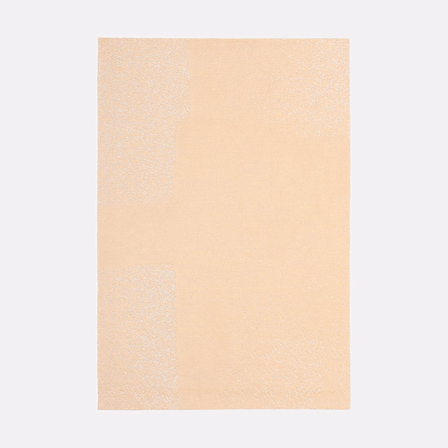 Pale peach jacquard with subtle tonal blocks and a softly granular woven texture