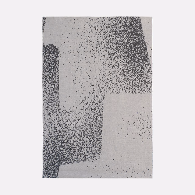 Cool grey jacquard with charcoal stippled blocks and pale geometric ground