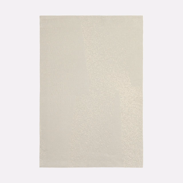 Pale cream jacquard swatch with faint vertical tonal shifts and a softly mottled weave