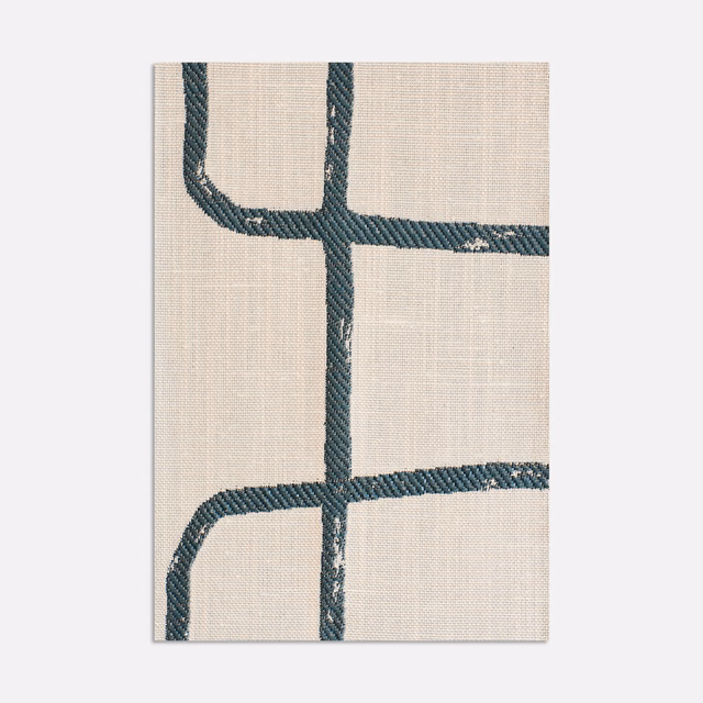 Ivory jacquard with dark blue-green irregular grid lines and textured woven surface