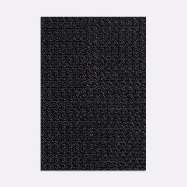 Near-black jacquard swatch with a fine repeating geometric weave