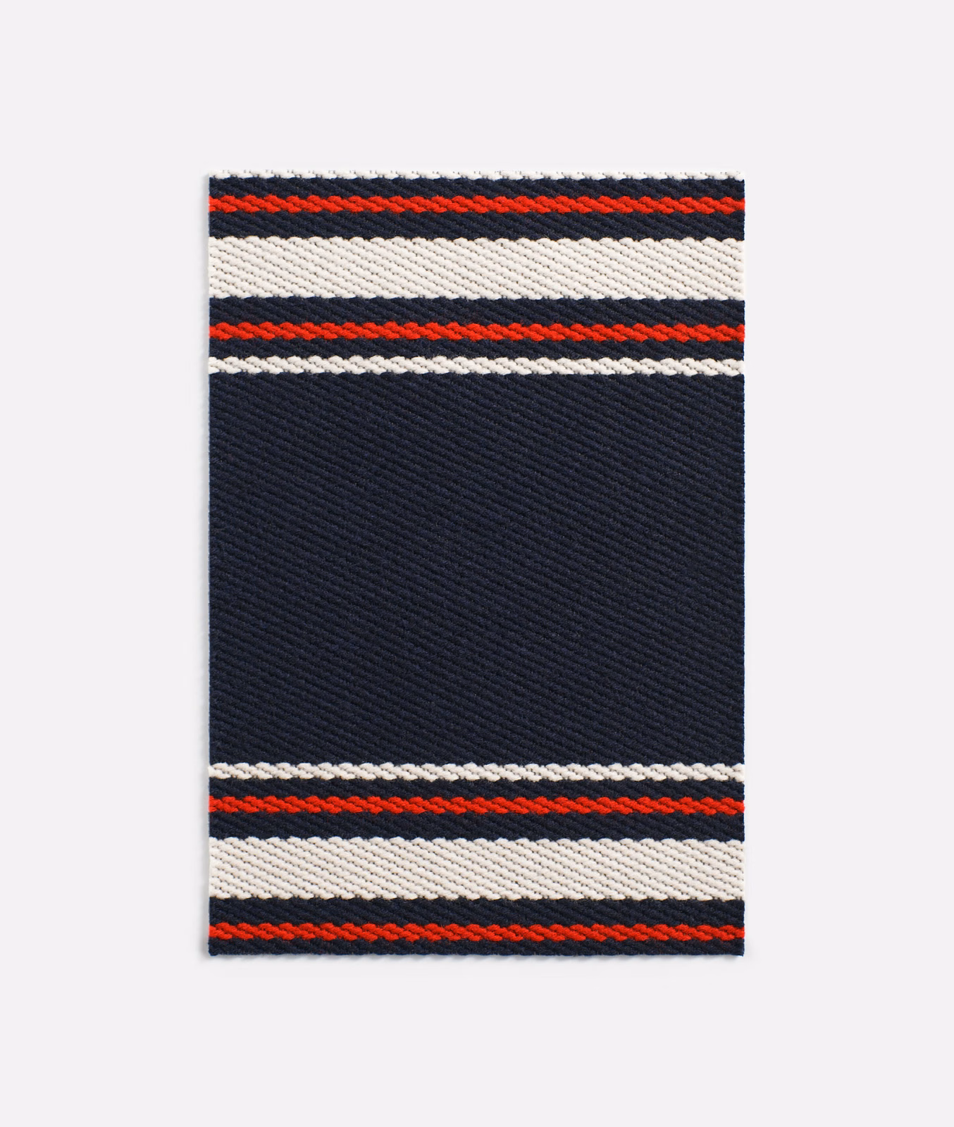 Deep navy twill with red, white and black horizontal woven bands