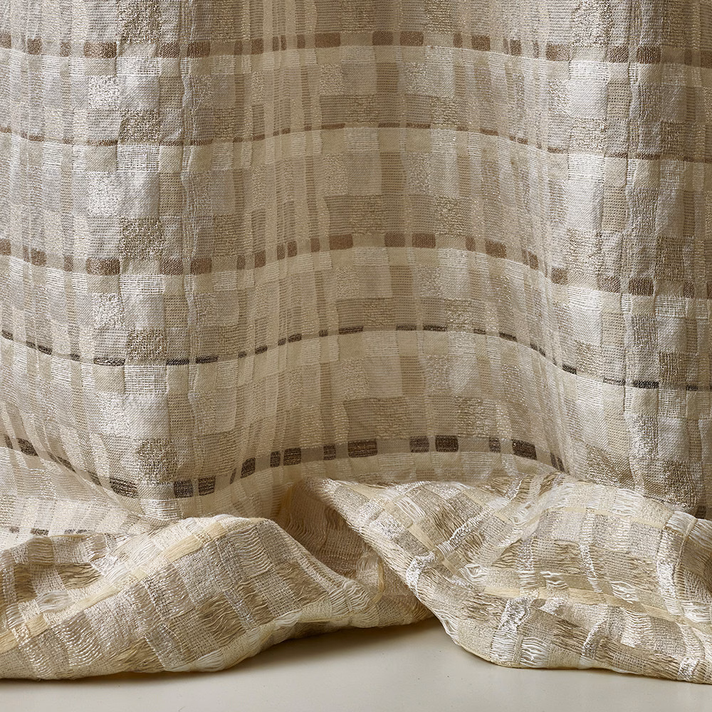 Warm ivory jacquard with taupe grid blocks and softly rippled folds