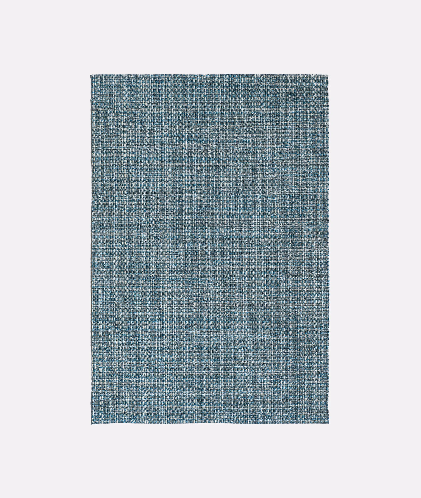 Close view of muted indigo-blue jacquard with a dense, crosshatched woven texture