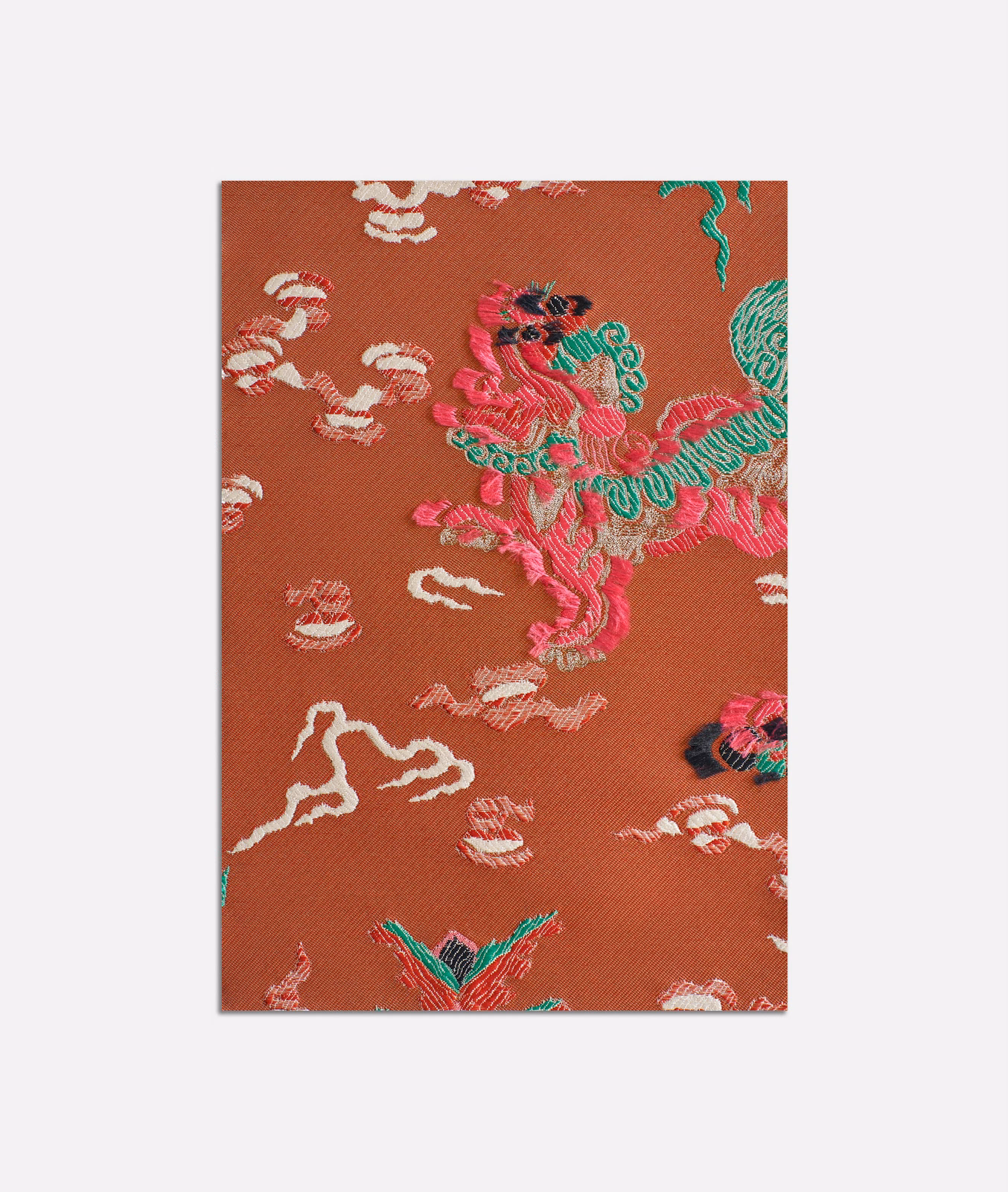 Terracotta jacquard with turquoise, pink and cream embroidered-style motifs