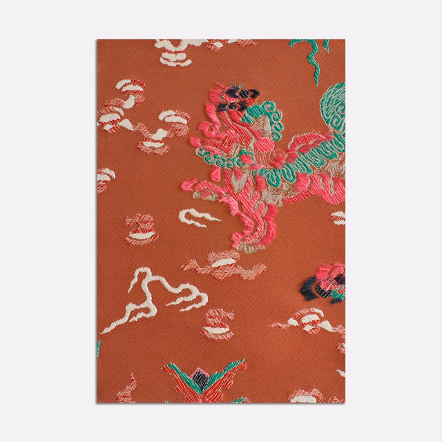 Terracotta jacquard with turquoise, pink and cream embroidered-style motifs