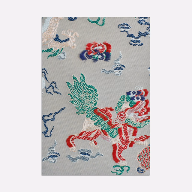 Pale blue-grey jacquard with red, green and navy ornamental figures