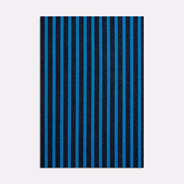 Cool teal and black vertical striped jacquard fabric with a dense woven surface