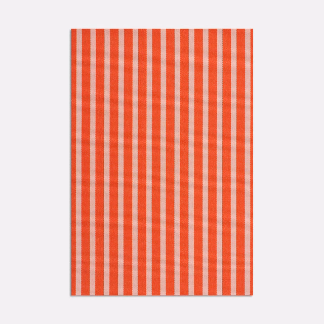Warm coral-red and ivory vertical stripes with a fine woven jacquard texture