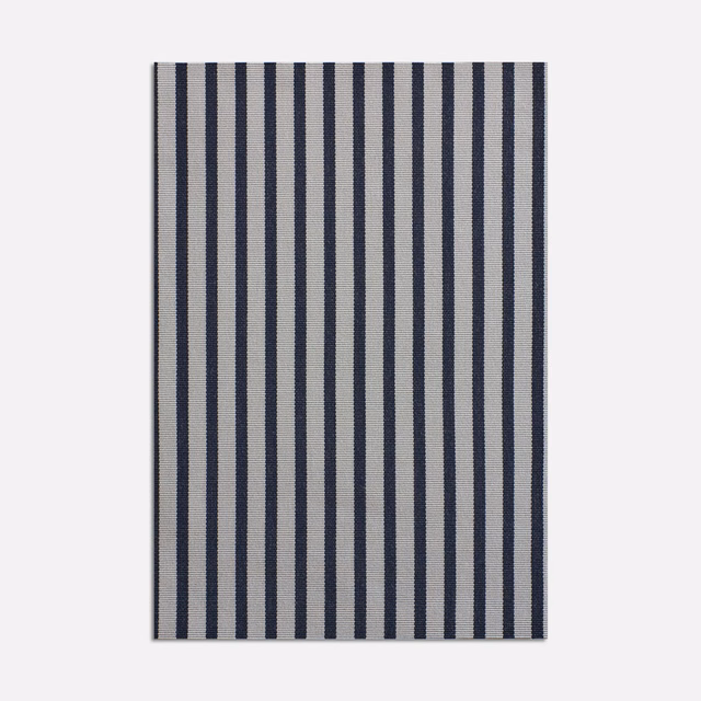 Ink navy and ivory vertical stripes on a lightly grainy woven surface