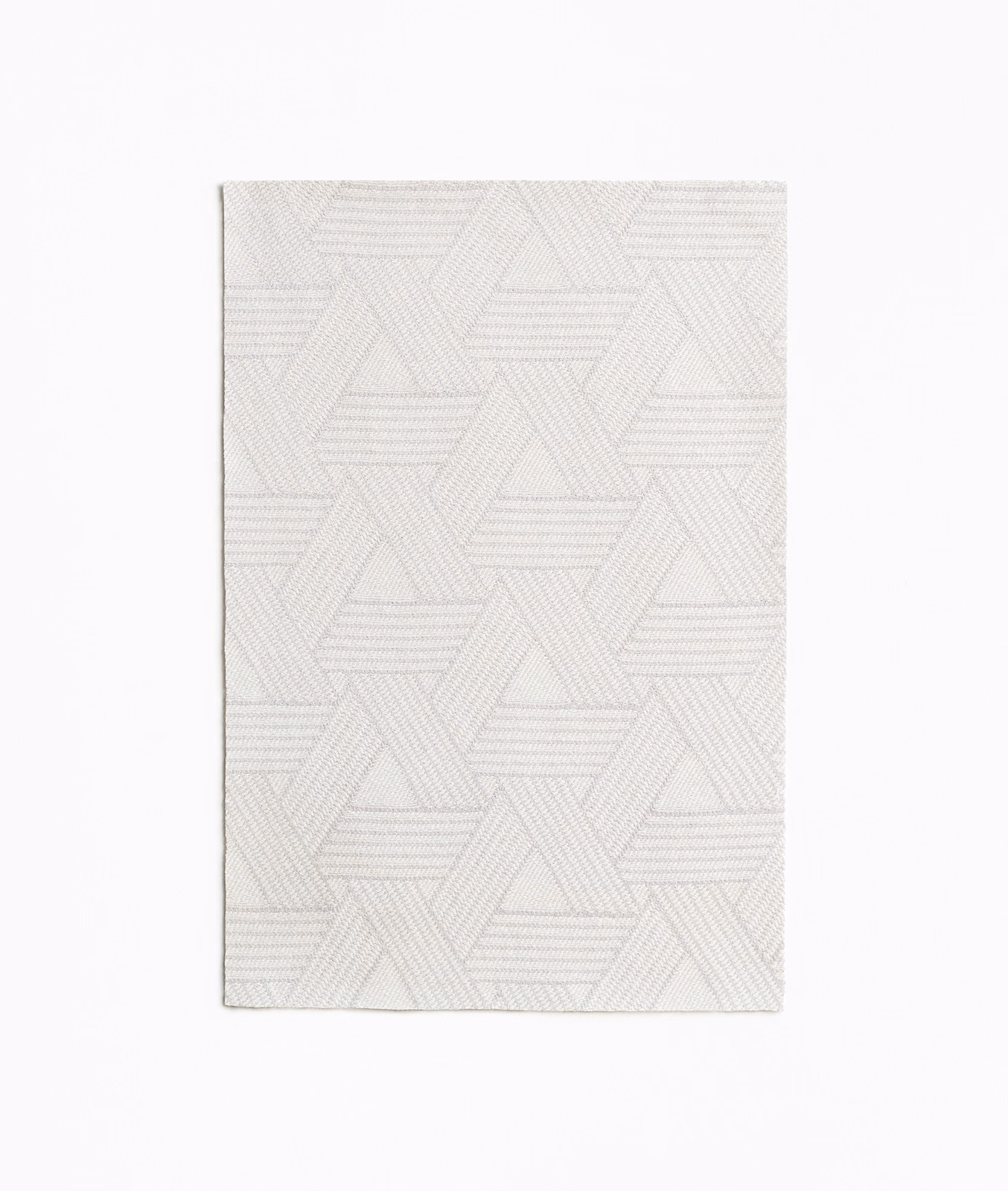 Pale pearl jacquard swatch with layered triangular outlines and fine horizontal woven ridges