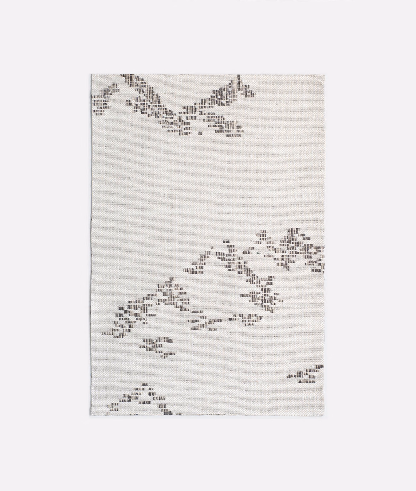 Pale grey jacquard with scattered charcoal pixel-like motifs and woven texture