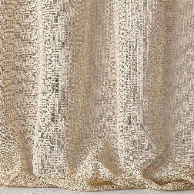 Warm ivory open-grid jacquard fabric draped in soft, fluid folds