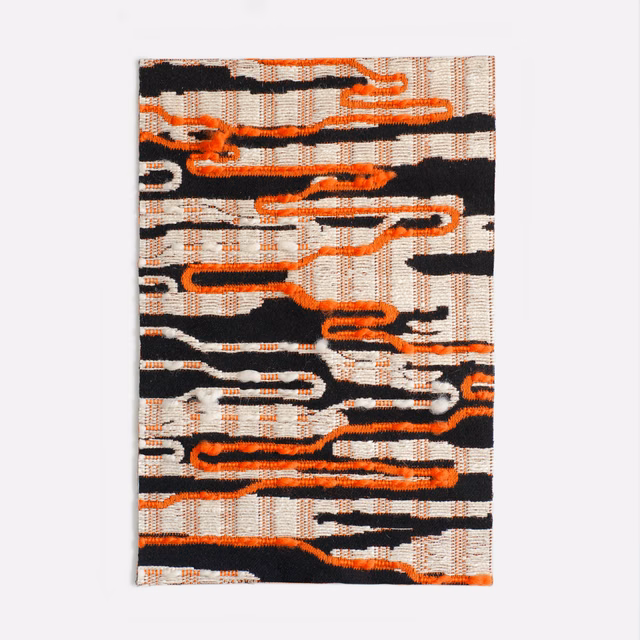 Black and white jacquard with vivid orange meandering lines and raised woven texture