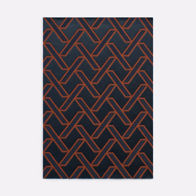 Near-black jacquard with repeating brick-red interlocking geometric lines