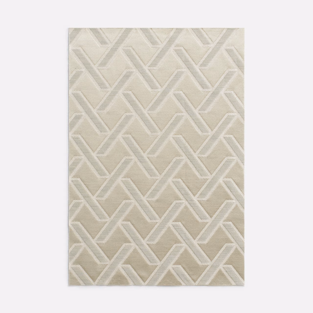 Warm écru jacquard with raised ivory interlocking chevrons and subtle woven texture