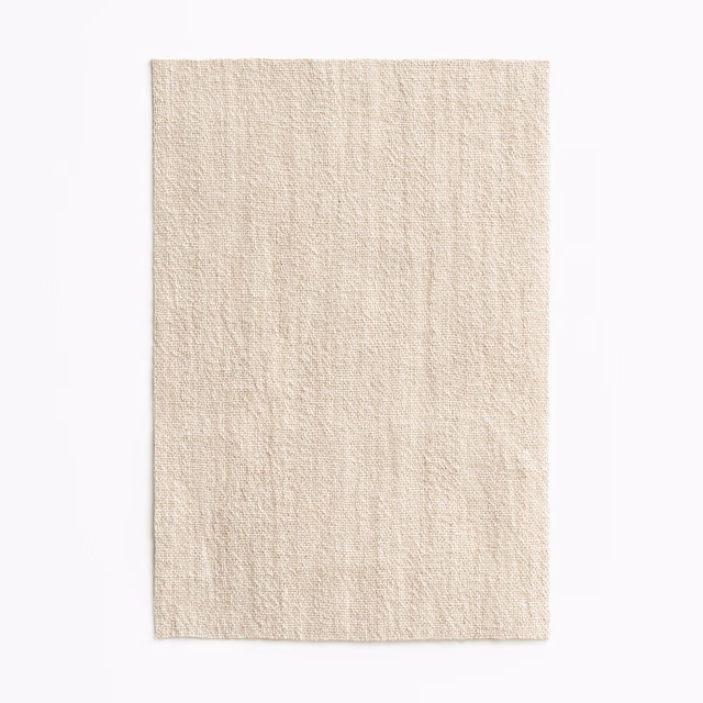 Pale ivory jacquard swatch with fine slubs and subtle vertical striations